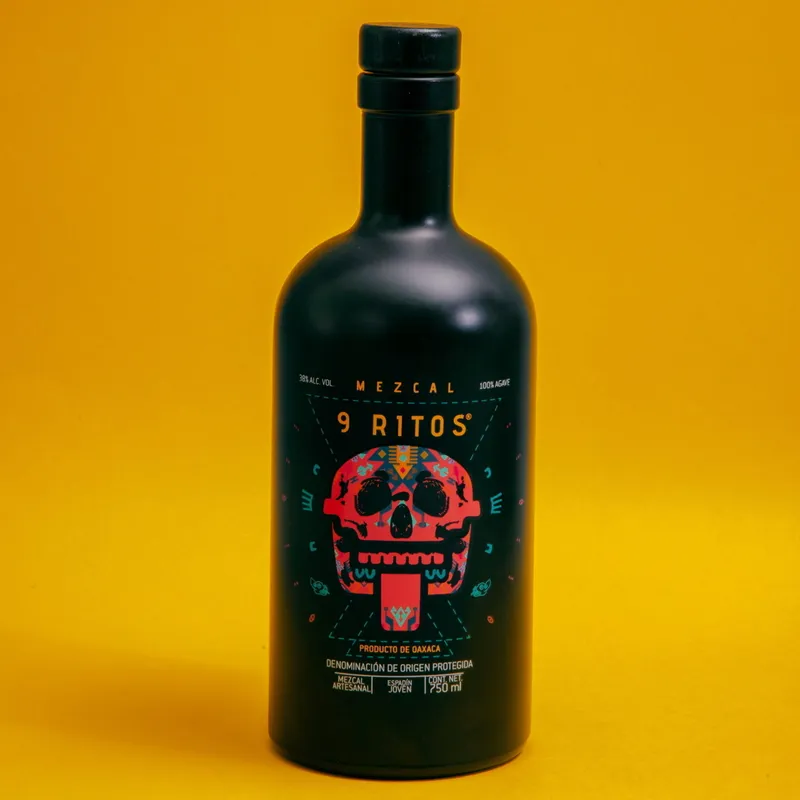 750 ml bottle of Mezcal 9 Ritos on a yellow background